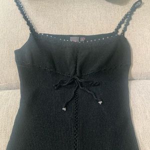 Small ribbed black tank top with crocheted straps accented with clear beads.